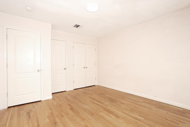 unfurnished bedroom featuring light wood-type flooring