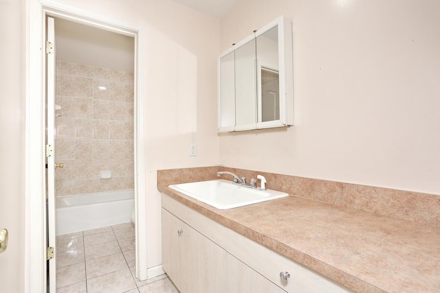 bathroom featuring tiled shower / bath combo, tile patterned floors, and vanity