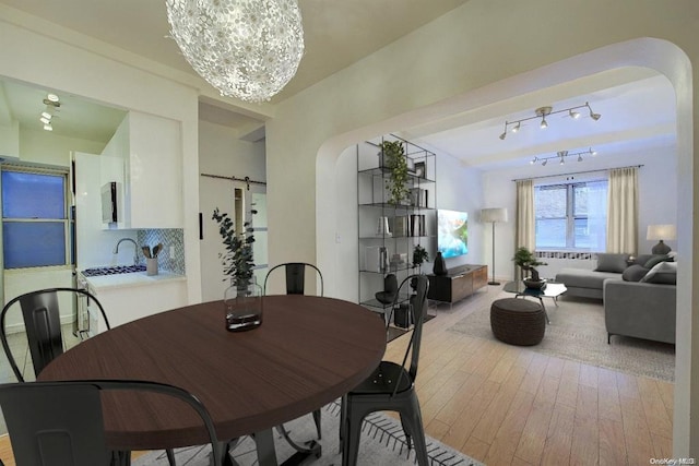 dining room with a chandelier and light wood-type flooring