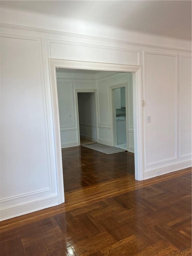 unfurnished room featuring dark parquet flooring