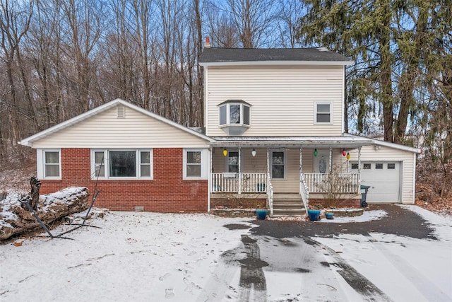 view of front of property featuring covered porch and a garage