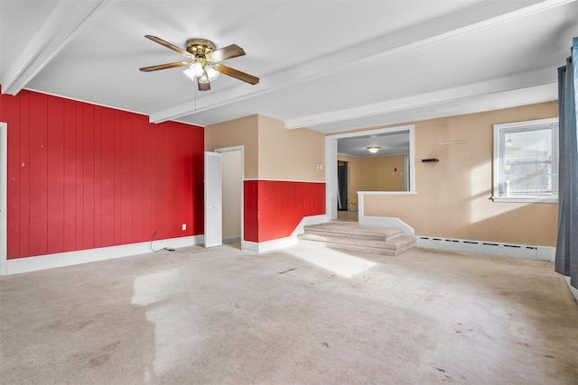 spare room featuring a baseboard heating unit, light carpet, beamed ceiling, wood walls, and ceiling fan