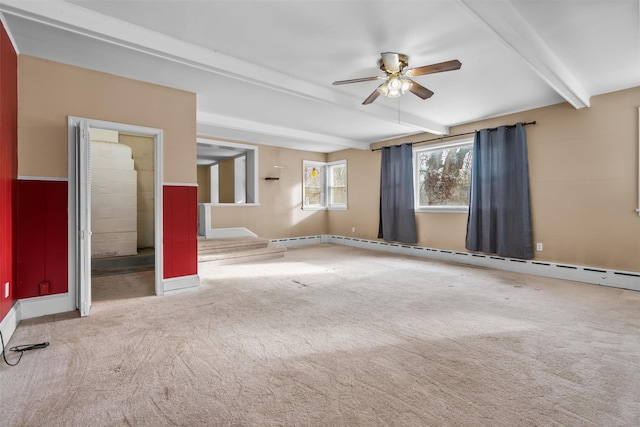 spare room featuring a baseboard heating unit, ceiling fan, carpet flooring, and beamed ceiling