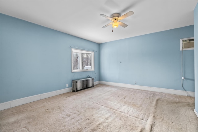 empty room with light carpet, an AC wall unit, radiator heating unit, and ceiling fan