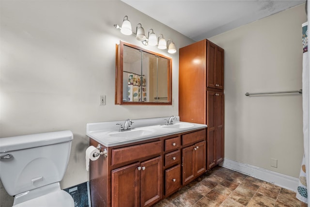 bathroom with toilet and vanity