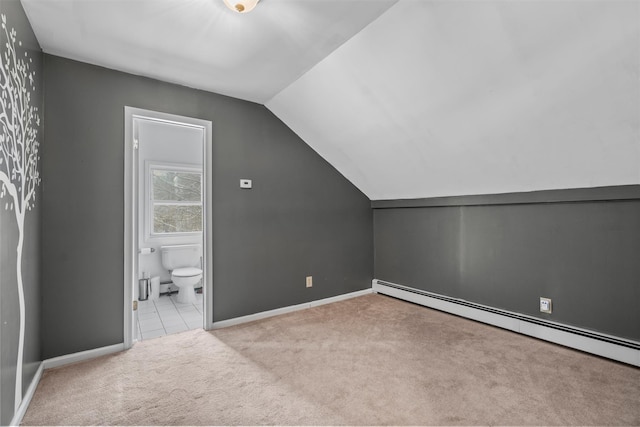 bonus room with a baseboard heating unit, light carpet, and vaulted ceiling