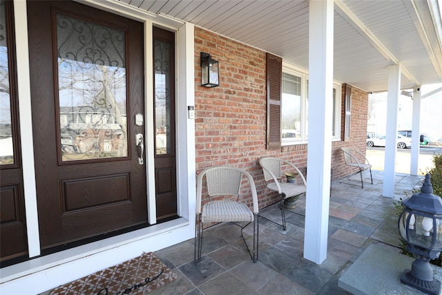 view of exterior entry with a porch