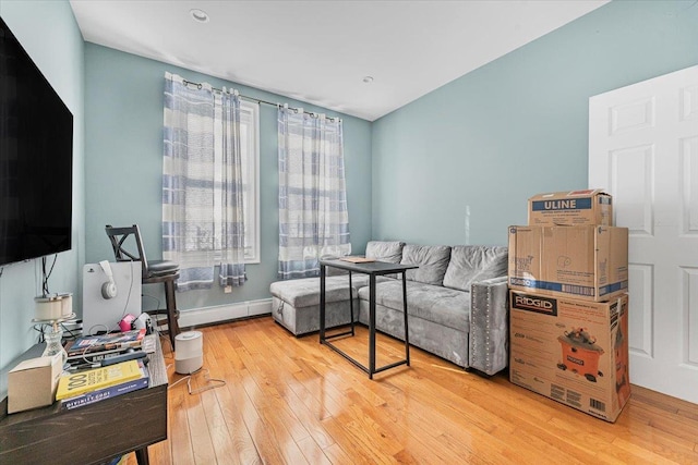 living room with a baseboard radiator and wood-type flooring