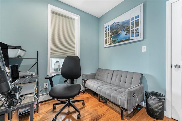 office area with a baseboard radiator and hardwood / wood-style floors