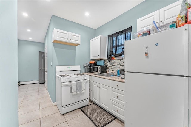 kitchen featuring white cabinetry, light tile patterned floors, white appliances, and a baseboard heating unit