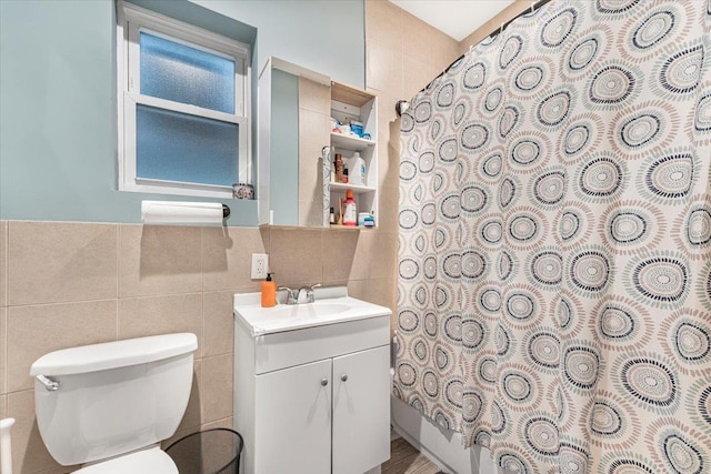 full bathroom with toilet, tile walls, shower / tub combo, and vanity