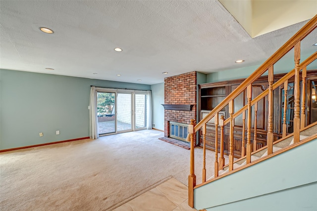 unfurnished living room featuring a textured ceiling, carpet floors, and a fireplace