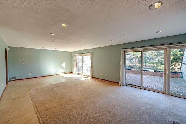 unfurnished room featuring a textured ceiling