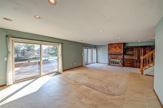 unfurnished living room featuring a fireplace and light colored carpet