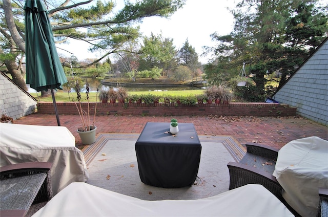 view of patio featuring a water view