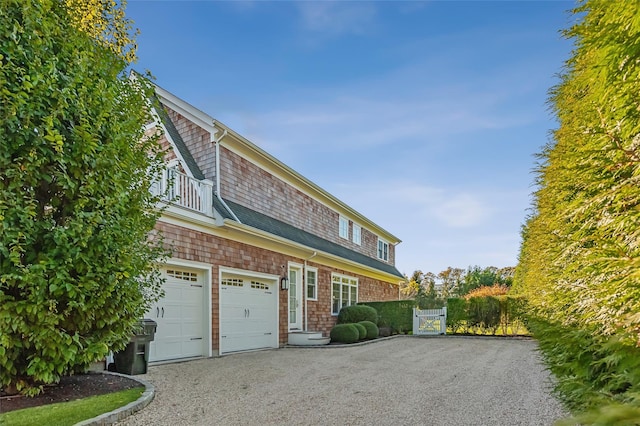 view of property exterior featuring a balcony and a garage