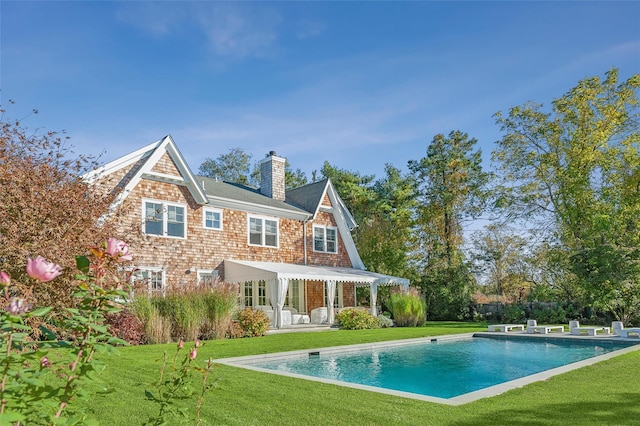 back of property with a patio area and a yard