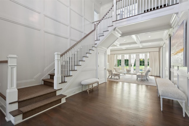 stairs featuring beam ceiling, wood-type flooring, french doors, and coffered ceiling