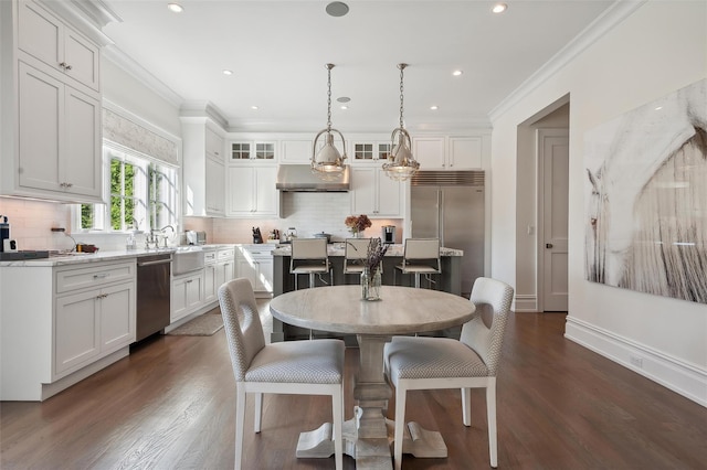 dining area with dark hardwood / wood-style floors and crown molding