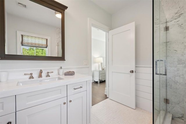 bathroom featuring tile patterned flooring, vanity, and a shower with door