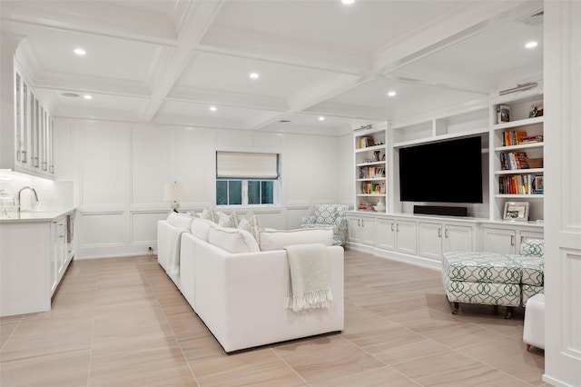 tiled living room featuring beamed ceiling, built in shelves, coffered ceiling, and sink