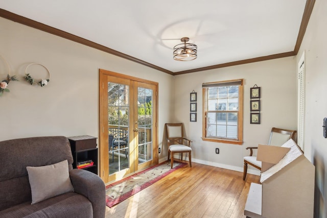 living area featuring ornamental molding, light hardwood / wood-style floors, and french doors