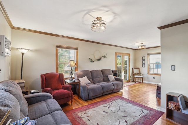 living room with hardwood / wood-style flooring, crown molding, french doors, and a wealth of natural light