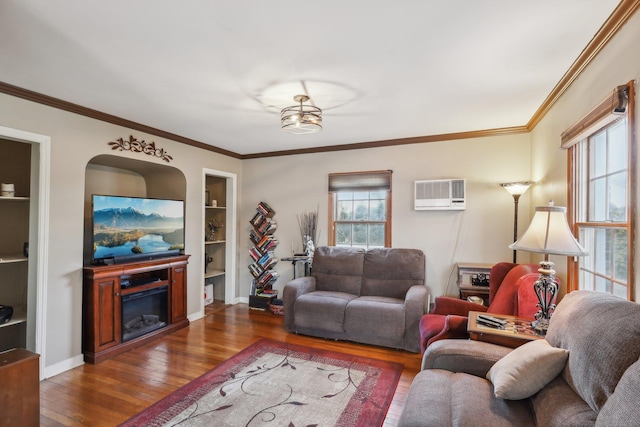 living room with a wall mounted air conditioner, a healthy amount of sunlight, dark wood-type flooring, and built in shelves