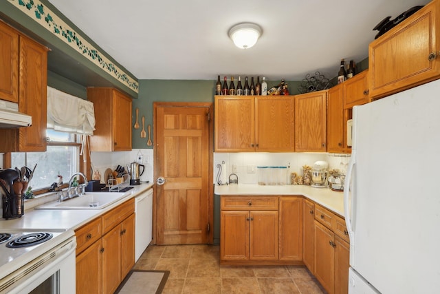 kitchen featuring white appliances, sink, and light tile patterned floors