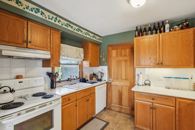 kitchen featuring sink, light tile patterned floors, white appliances, and decorative backsplash