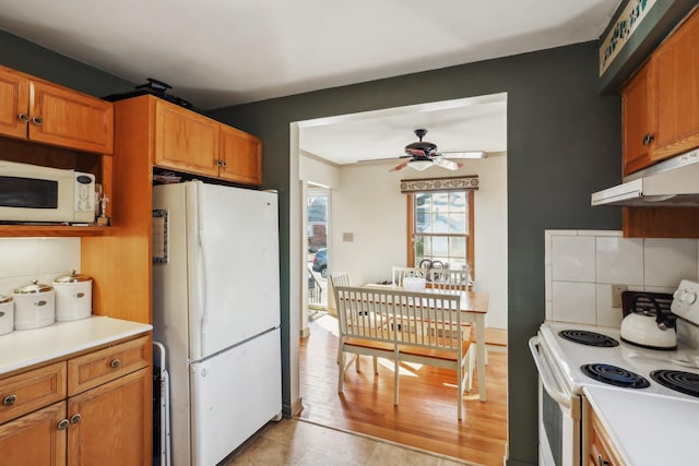 kitchen featuring ceiling fan, white appliances, and decorative backsplash