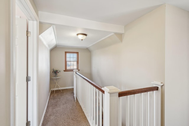 hallway with lofted ceiling and carpet