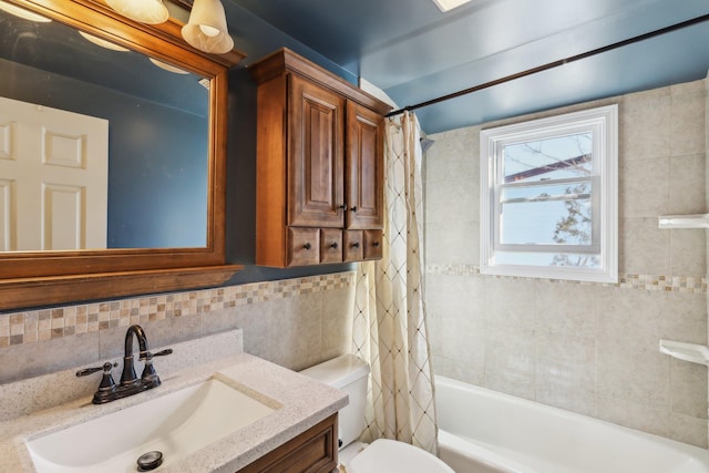 full bathroom featuring shower / bath combo, tile walls, vanity, decorative backsplash, and toilet