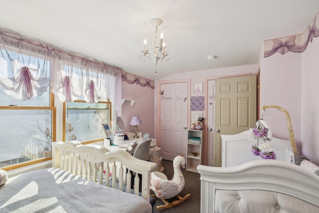 bedroom with vaulted ceiling and a chandelier