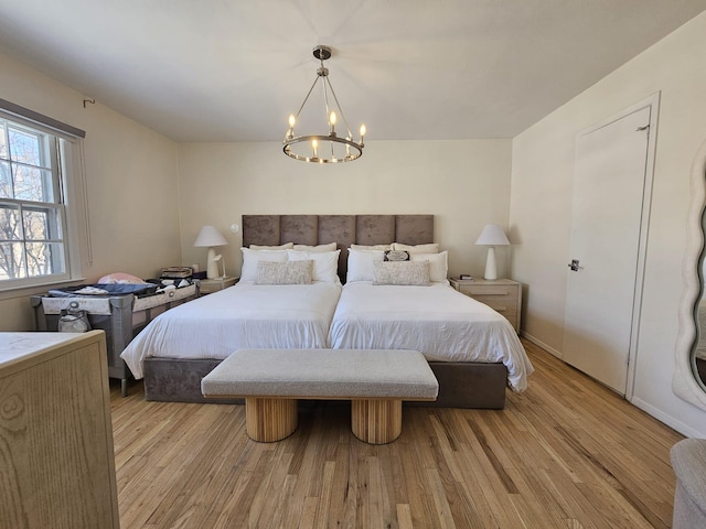 bedroom featuring a notable chandelier and light hardwood / wood-style floors