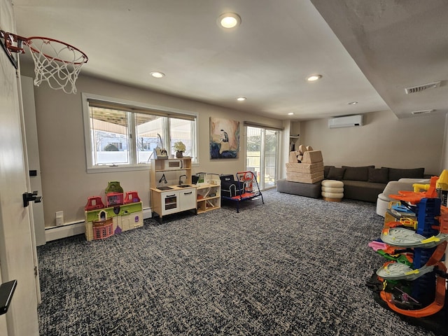 playroom featuring baseboard heating, a wall mounted AC, and dark carpet