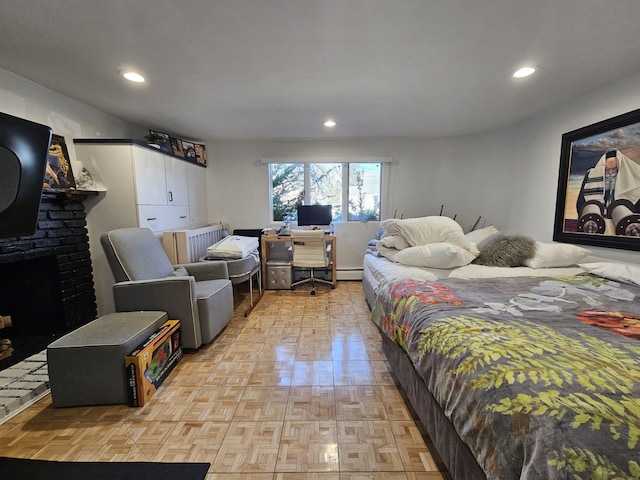 bedroom featuring light parquet flooring and a fireplace