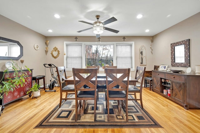 dining area with hardwood / wood-style flooring and ceiling fan