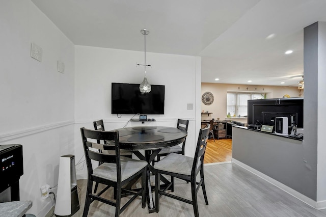 dining space with hardwood / wood-style floors