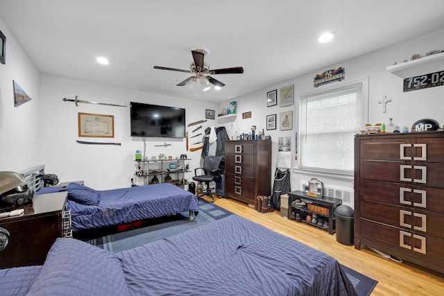 bedroom with ceiling fan and light wood-type flooring