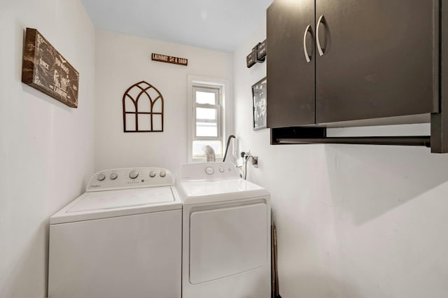 laundry area with cabinets and washer and clothes dryer