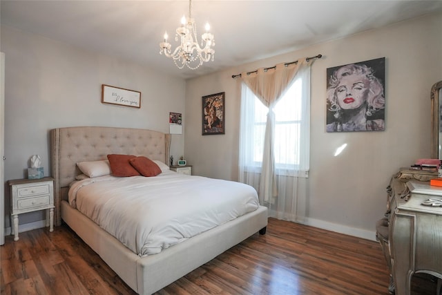 bedroom with dark hardwood / wood-style flooring and a chandelier