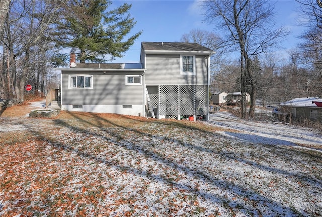 view of snow covered rear of property