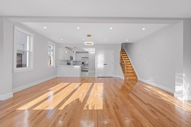 unfurnished living room featuring light hardwood / wood-style floors