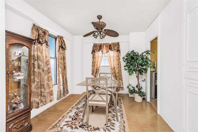 dining space with light wood-type flooring and ceiling fan