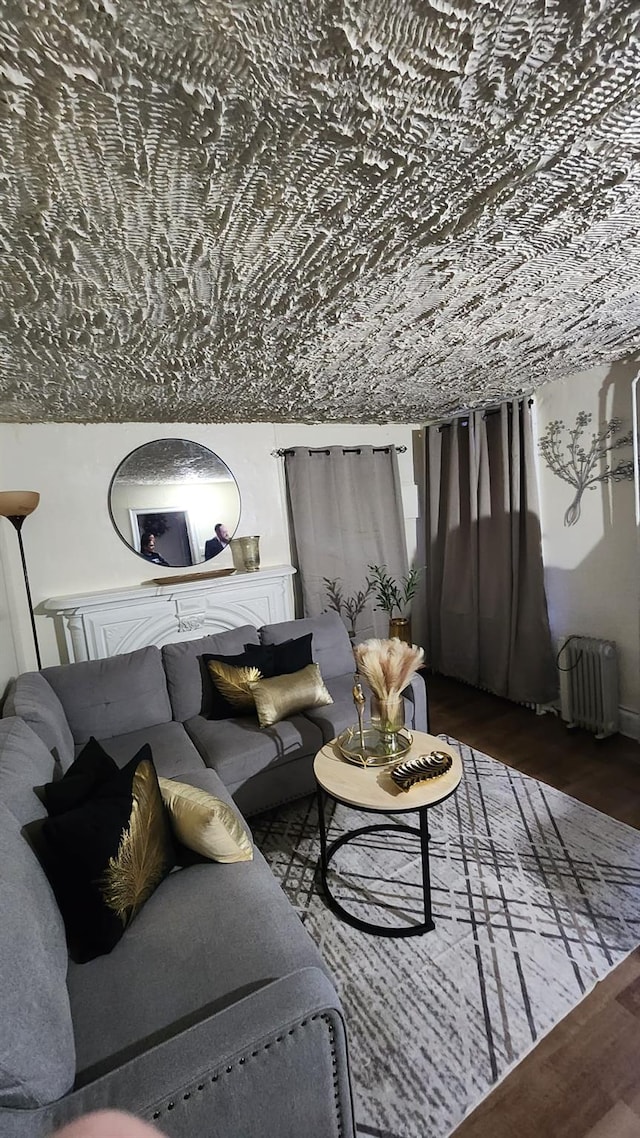 living room with radiator and dark wood-style flooring