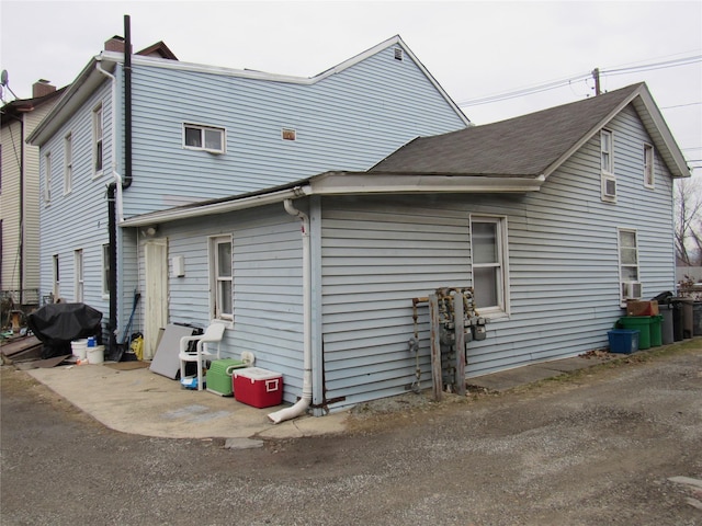 view of side of property featuring cooling unit and a patio