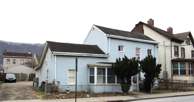 view of front of home featuring fence