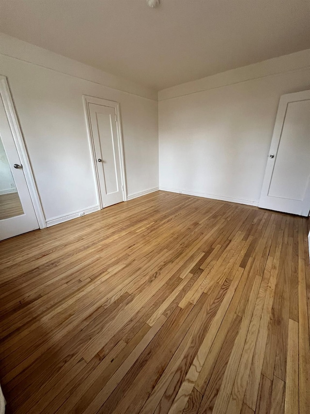 spare room with light hardwood / wood-style flooring