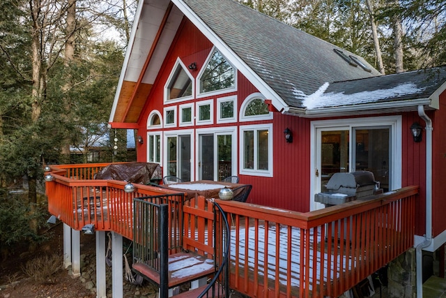 rear view of house with a wooden deck